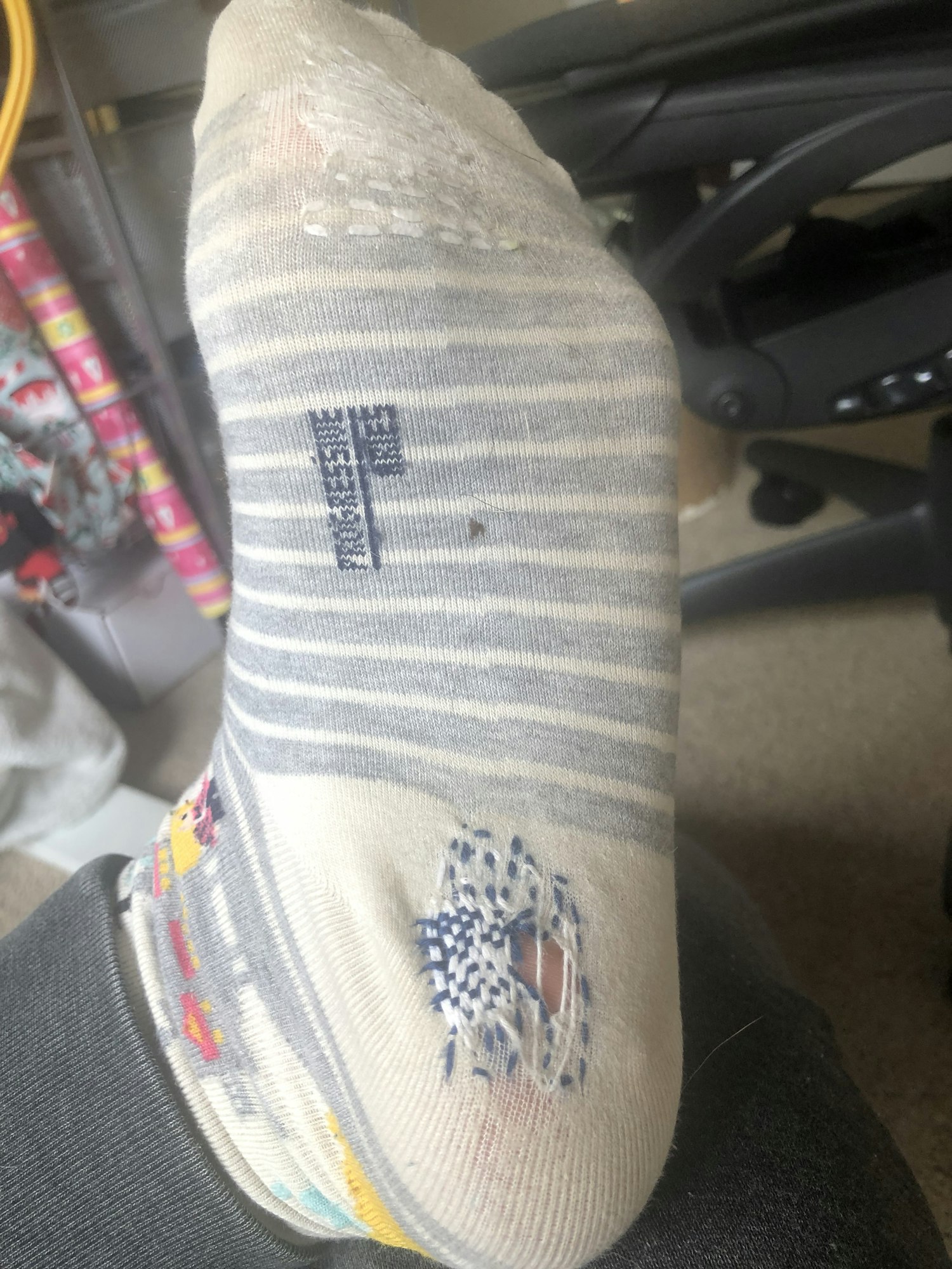 Mended socks with a hole using darning technique